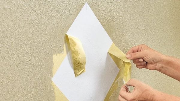With a slight drying of the paint, remove the masking tape from the wall