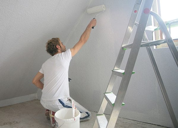 Application of primer on a painted wall