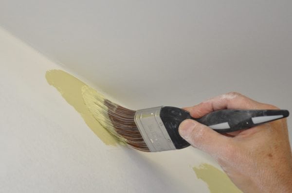 Painting walls with mother-of-pearl paint brush