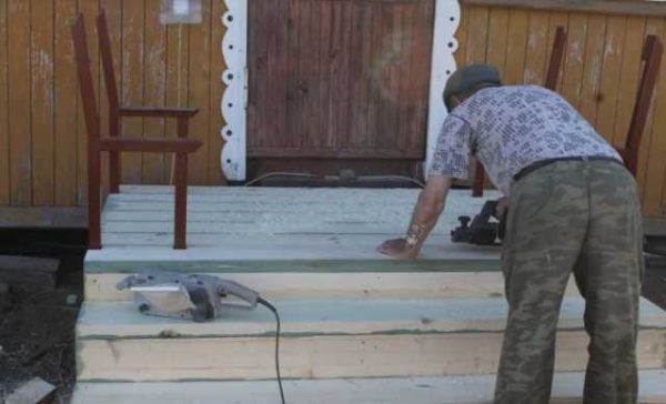 Preparing a wooden porch for painting