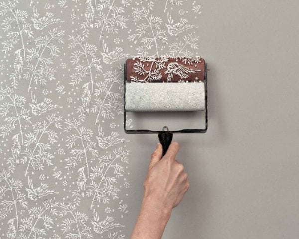 Drawing a picture on a wallpaper with a relief roller