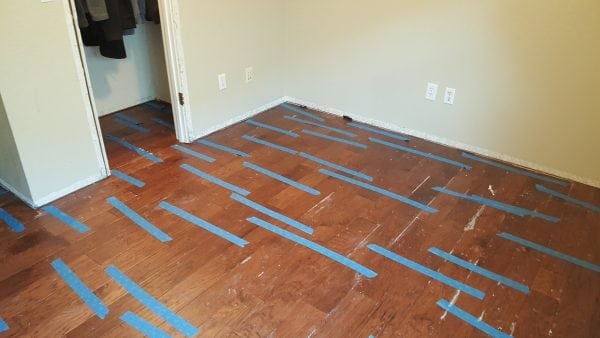 Sticking double-sided tape on a wooden floor