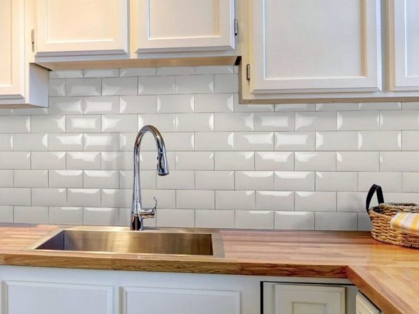 To decorate the walls in the kitchen, tiles are usually used.